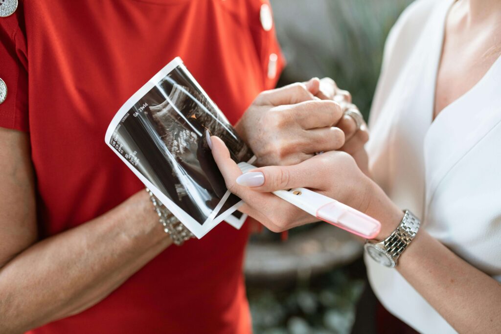 age and fertility, women holding pregnancy test and ultrasound