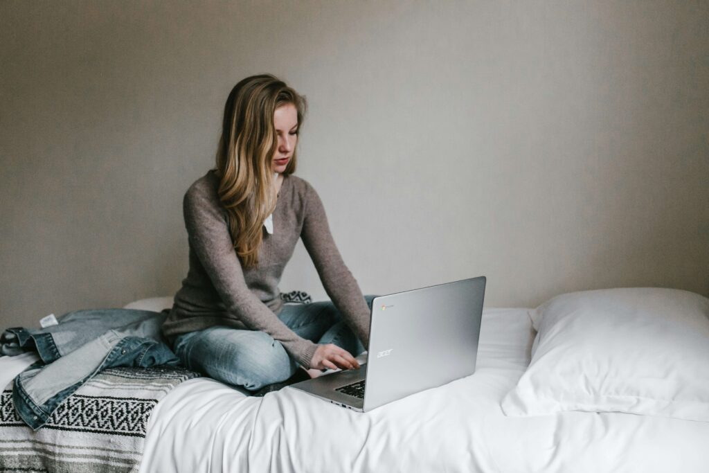 woman typing on laptop tracking fertility window