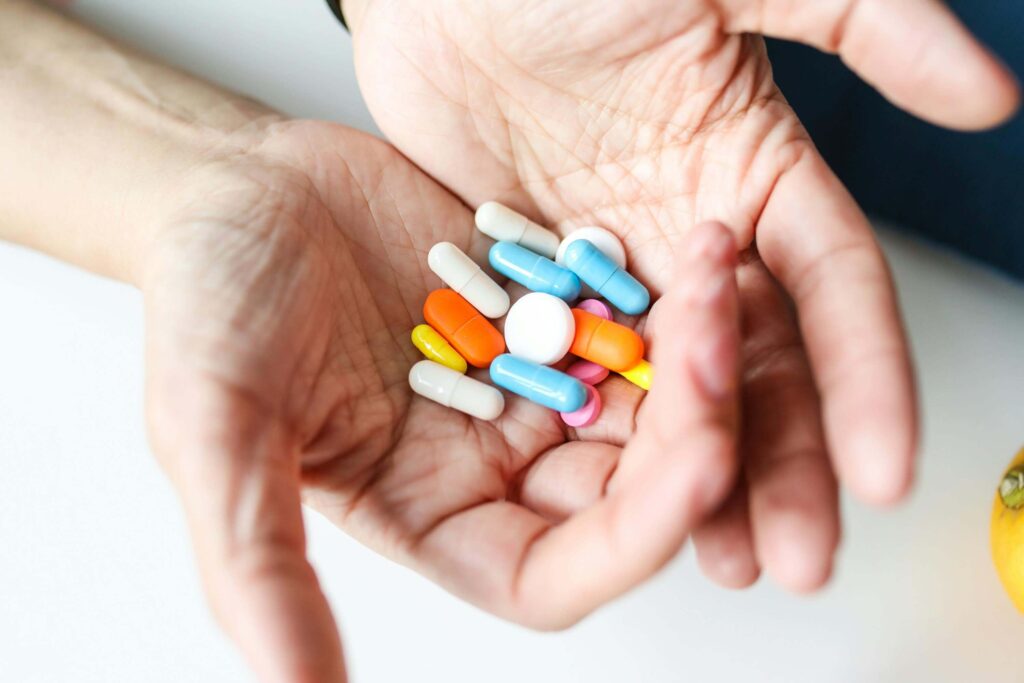 woman holding pills in hands